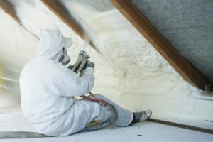 Technician installing spray foam insulation